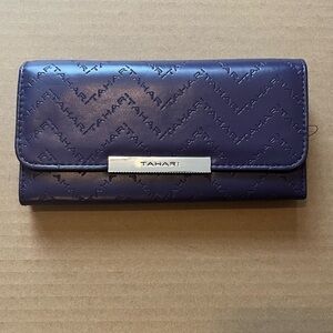 Purple Tahari Wallet. New without tags. Snap Closure. Zipper pocket inside.